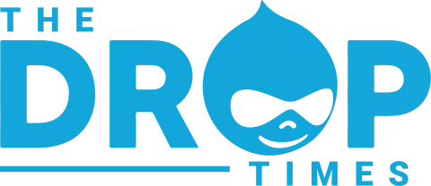 The Drop Times logo in blue featuring a stylized Drupal drop mascot and bold text.